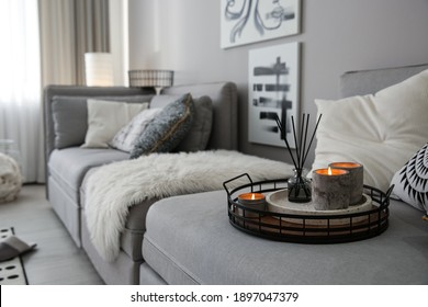 Candles and aroma reed diffuser on grey sofa, space for text - Shutterstock ID 1897047379