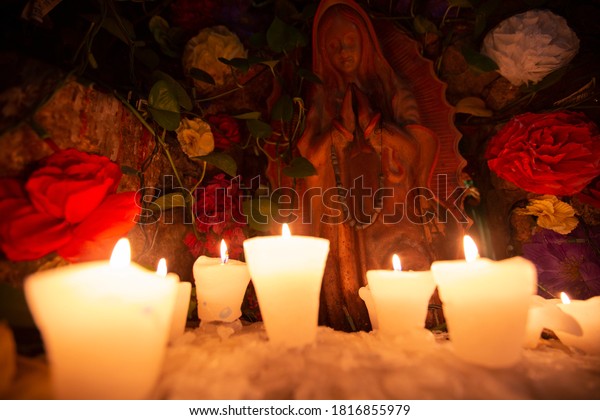 Candles burn in a votive offering\
to Saint Mary in Cabo San Lucas, Baja California Sur,\
Mexico.