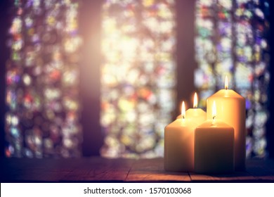 Candles burning in a church background