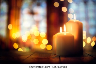 Candles burning in a church background