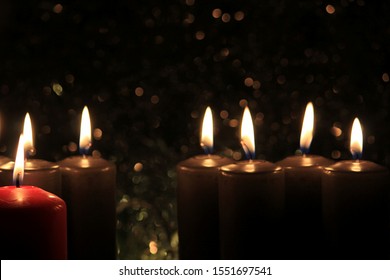 Candles Burning at Night. Golden and Red Candles Burning in the Dark with lights glow. 
