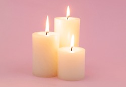 Candles Burning On Pink Background.