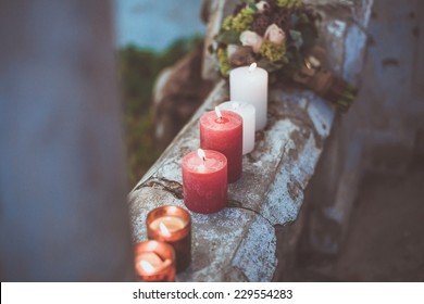 Candles burning on a stone wall at a wedding reception  - Powered by Shutterstock