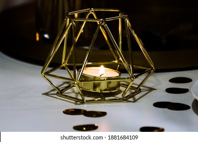 Candles In Gold On The White Table In Holiday