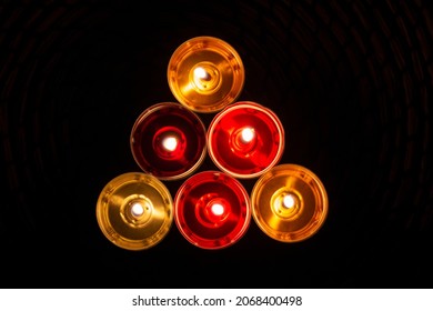 The Candles Are Laid Out In A Triangle. Candles Burn In The Dark. Red And Yellow Wax. The Combustion Process.