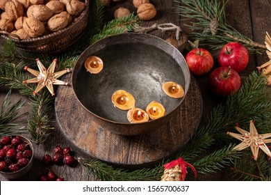 Candles made from nut shells floating in a bowl of water - old Christmas custom