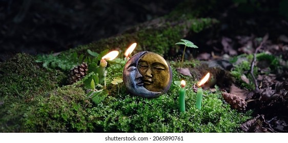 candles and symbol of moon on dark forest natural background. pagan Wiccan, Slavic traditions. Witchcraft, esoteric spiritual ritual. witch magic practice. Mysticism, divination, modern wiccan occulti