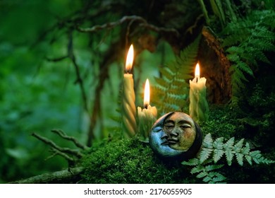 candles and symbolic moon amulet on dark forest background. pagan Wiccan, Slavic traditions for Litha. Witchcraft, esoteric spiritual ritual, magic practice. Mysticism, divination, occultism concept.