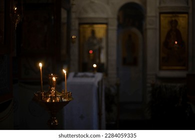 Candles in Temple. Interior of Church. Details of religious rite. Flame of candles inside holy place. - Powered by Shutterstock