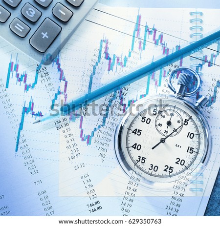 Candlestick graph chart, pencil and stopwatch in toning