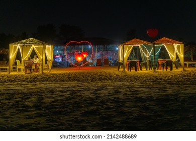 CANDOLIM, March 2022: A young couple having candle light dinner in a beach shacks on Candolim beach Goa, India.