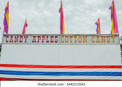 Candy apples and Cotton Candy food booth set up at the Fourth of July Independence day fair and carnival in Erath, Louisiana.