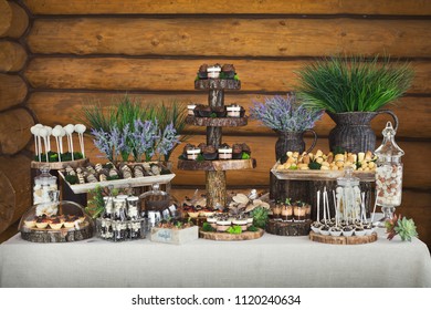 Candy Bar For Birthday Party Or Wedding. Desserts Assortment Against Wooden Background