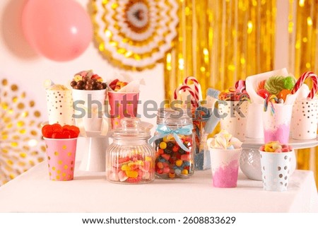 Candy bar. Many different sweets on table in festive decorated room