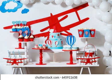 Candy Bar On Boy's Birthday Party With A Lot Of Different Candies, Popcorn, Beverages And Big Cake. Decorated In Blue,red And White Colors, Balloons Or Aviation Theme, Indoor