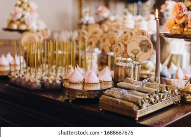 candy bar, sweets, sweets, chocolate, lollipops, cakes and macaroons are laid out on beautiful trays and decorated with flower arrangements