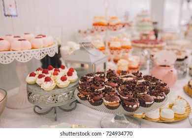 Candy Bar At A Wedding With Tasty Sweets And Mini Cakes.