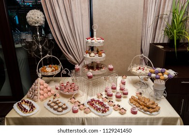 Candy Bar/Wedding Candy Bar Display Featuring All Sorts Of Delicious Cookies And Sweets Arranged In Special Trays And Supports.