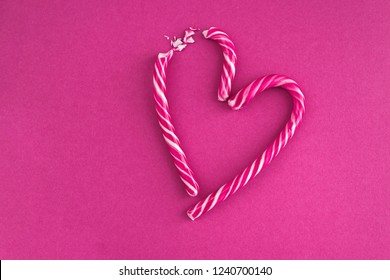 Candy Cane Broken Heart On Pink Background.