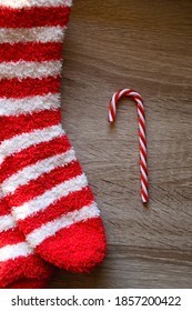 Candy Cane Decoration And Striped Fuzzy Socks. Top View.