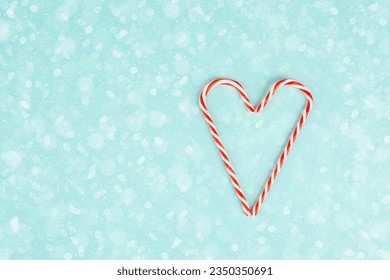 Candy cane forms heart shape, Christmas holiday background, winter season greeting card  - Powered by Shutterstock