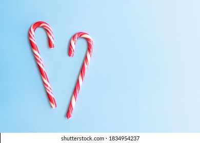 Candy cane on a blue background. Chrismas sweets. New year concept. - Powered by Shutterstock