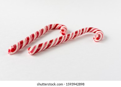 Candy candy cane on a white background. Symbol of the new year. Children's sweetness.