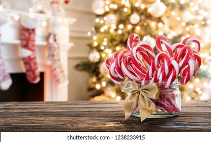 Candy canes in the glass jar on the christmas table with copy space  - Powered by Shutterstock