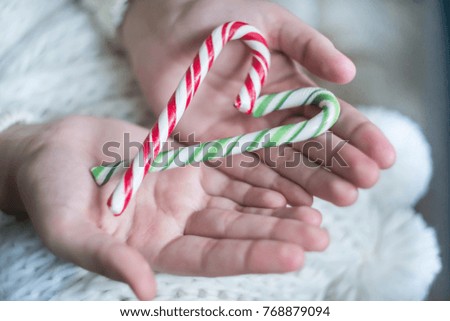 candy canes in the hands of the girls
