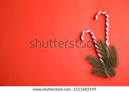 Candy canes on red background, flat lay. Space for text
