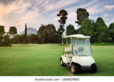 Candy Car / Golf Car Parked In Mountain Panoramic Natural Summer Landscape Background At Sunset