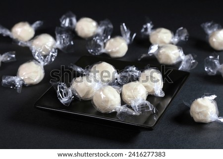 Candy cheese on a plate and plural candy cheese on black background