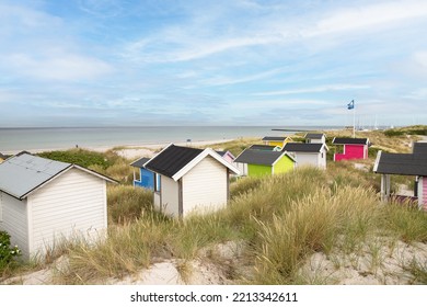 Candy Coloured Beach Huts In The Sand Dunes. Sweden, Skanör, 1 July 2022