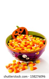 Candy Corn Cadnies In Halloween Bowl On A White Background.