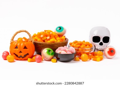 Candy corn isolated white background Halloween concept  Bucket Halloween pumpkin Jack  o  lantern and candy corn for halloween celebration Pumpkin and scary smile his face Candy bucket 
