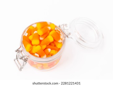 Candy corn isolated white background Halloween concept  Bucket Halloween pumpkin Jack  o  lantern and candy corn for halloween celebration Pumpkin and scary smile his face Candy bucket 