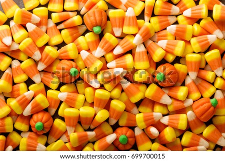 Candy corn and pumpkin Halloween background overhead shot