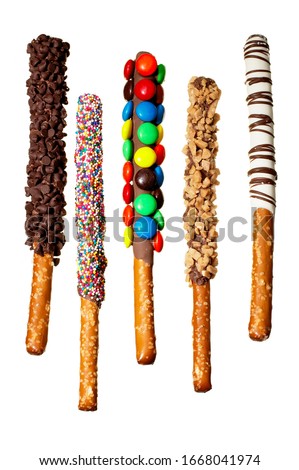 Candy Decorated chocolate covered pretzel rods on white background