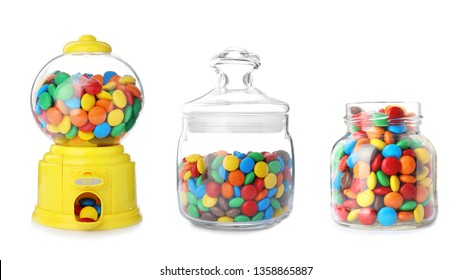 Candy dispenser and jars with colorful sweets on white background