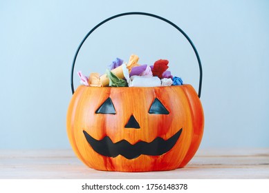 The candy put in a pumpkin-shaped basket which had a cool face, halloween party concept - Powered by Shutterstock