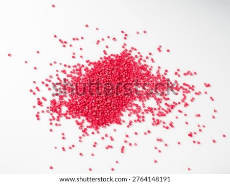 Candy red sprinkle pile, round scattered sugar sprinkles isolated, sweet pink confectionery decoration, many small sugar balls on white background top view