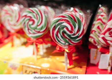 Candy Shop. A vibrant display of brightly colored swirled lollipops  candies. Colorful sweet lollipops wrapped and displayed for sale. - Powered by Shutterstock