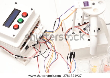 Candy sorting machine prototype with control panel. DIY electronics project using 3D print technology. Homemade automation device for color recognition and candy separation.