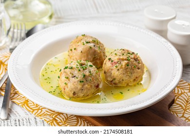 Canederli or Knodel in broth with green onion, typical pasta or dumplings for Alps, Alto Adige, German, Italian, Austrian cuisine. Made from stale bread, milk, eggs, speck.	