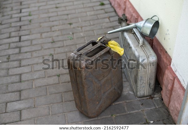 canister and watering can for diesel. the\
canister with the fuel and the filler\
funnel.