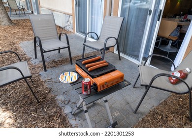 Canmore, Alberta, Canada - July 10, 2022: Makeshift Picnic Area With A Gas Camp Stove, Foldable Table, Paper Plates And Soda