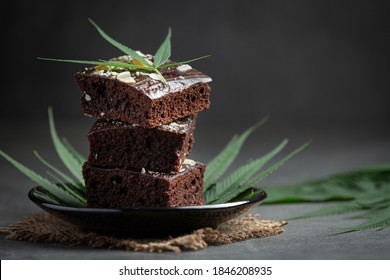 Cannabis Brownies And Cannabis Leaves Put On Black Plate