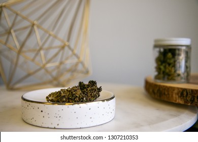 Cannabis Buds On Tray With Marijuana Shake In Glass Jar In Background - Cannabis Dispensary Products