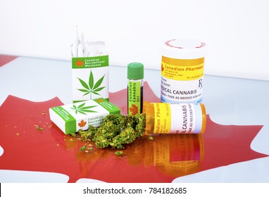 Cannabis in Canada. Marijuana cigarettes, cannabis oil, and prescription bottles for cannabis on a glass table. Buds spill from one of the bottles. Red maple leaf under the glass.