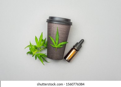Cannabis CBD Infused Coffee With Hemp Leaves And Cbd Oil Bottle, Concept Of Usage Of Cannabis In Food And Drink Industry